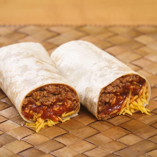 Two burritos filled with ground beef, red sauce, and shredded cheese on a woven mat.